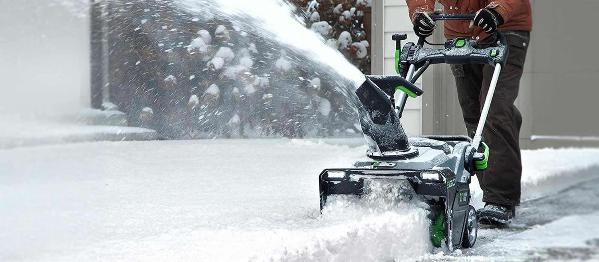 Mann befreit Einfahrt von Schnee mit Fräse von EGO Power+